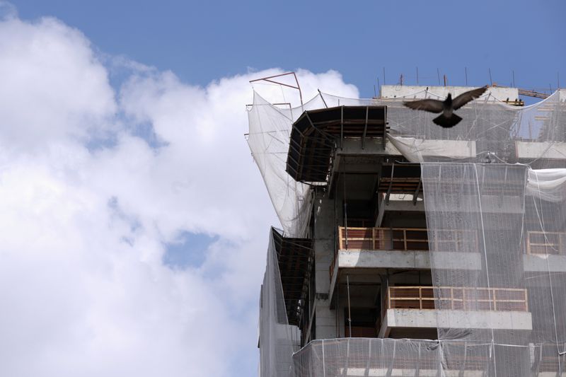 A construction site of a residential building is seen, amid