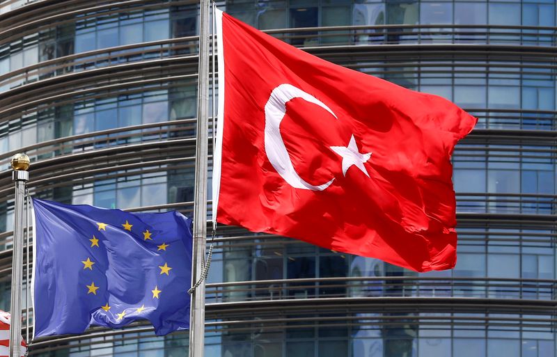 A European Union and Turkish flag fly outside a hotel