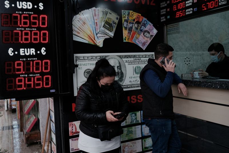 People wait to change money at a currency exchange office
