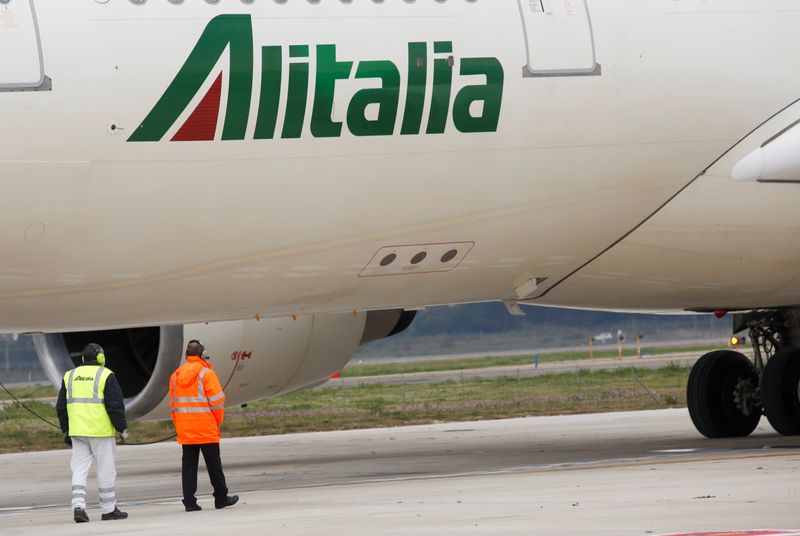 FILE PHOTO: Two workers are seen next to an Alitalia