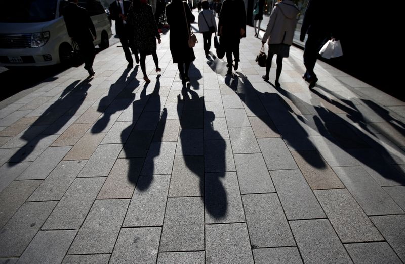 FILE PHOTO: Shadows of pedestrians are pictured cast on a