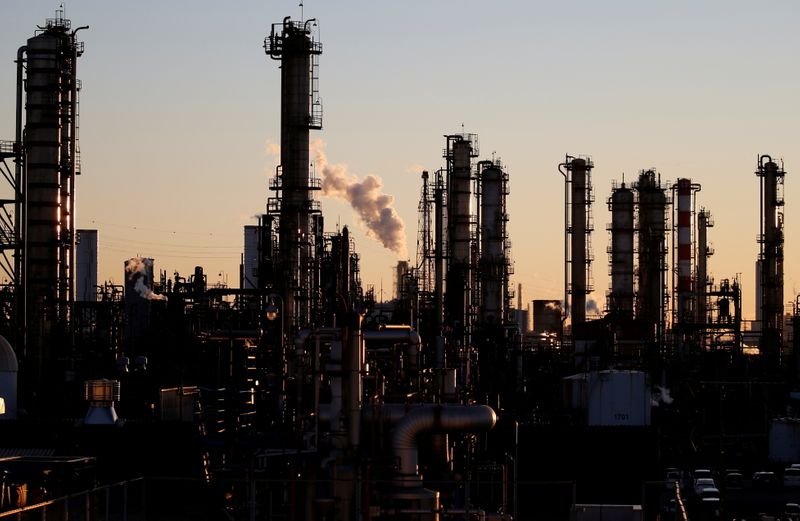 FILE PHOTO: Smoke rises from a factory during the sunset