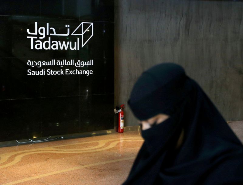 FILE PHOTO: Saudi woman walks at the Saudi stock market