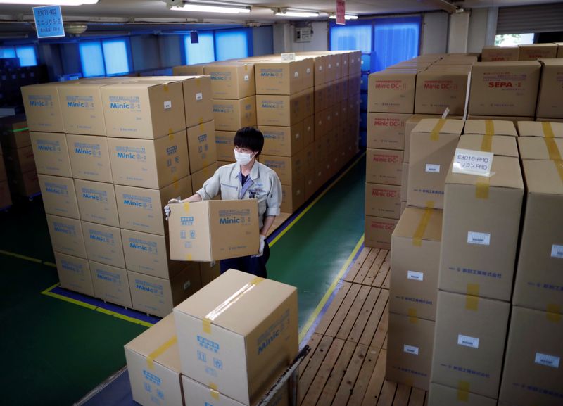 An employee of Sanko Manufacturing Co. conducts shipping operations of