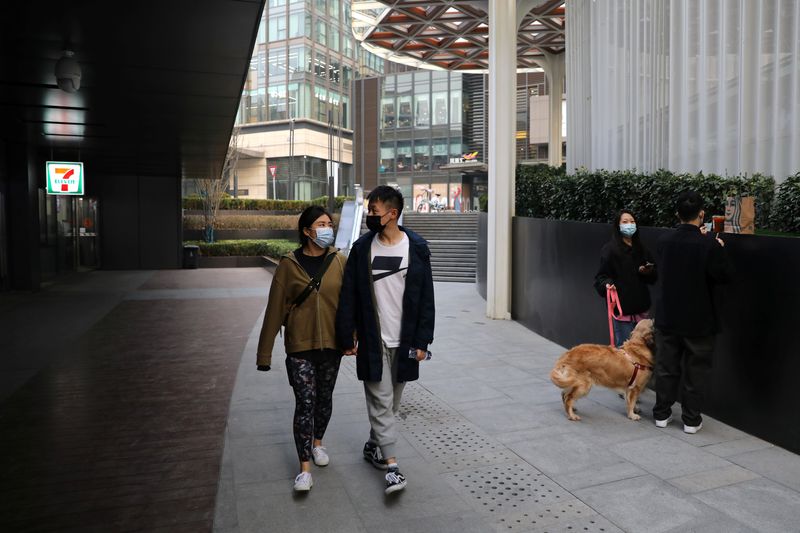 Married couple Liu Zhichang and Yu Tao walk at a