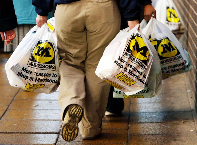 FILE PHOTO: A shopper leaves with her groceries at the