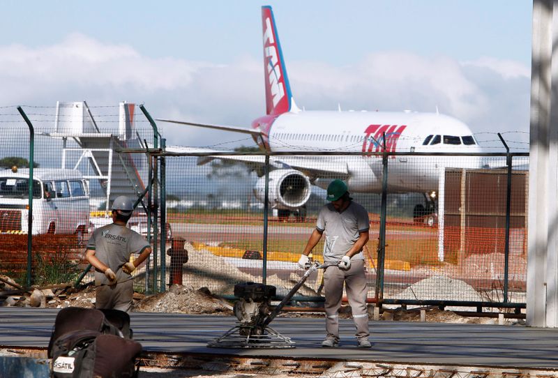 FILE PHOTO: Labourers work on the expansion of the Afonso