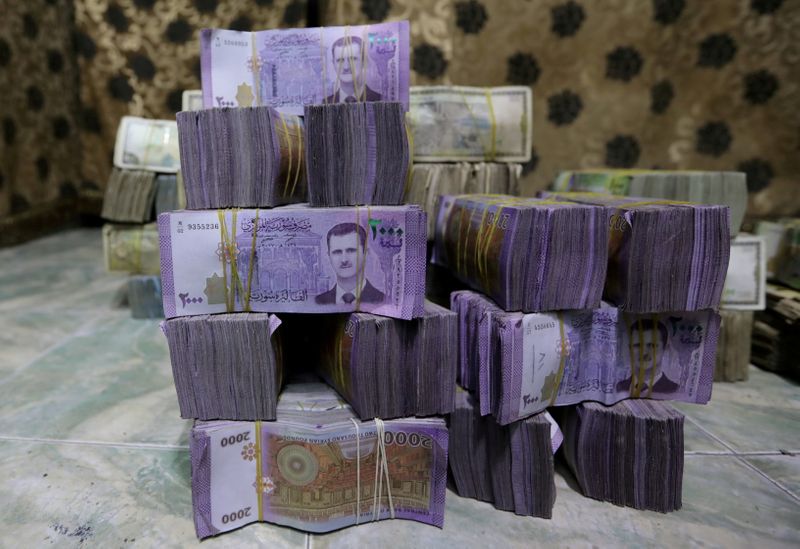 FILE PHOTO: Syrian pounds are pictured inside an exchange currency