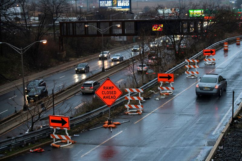 Cars drive along the NJ 495 route while road work