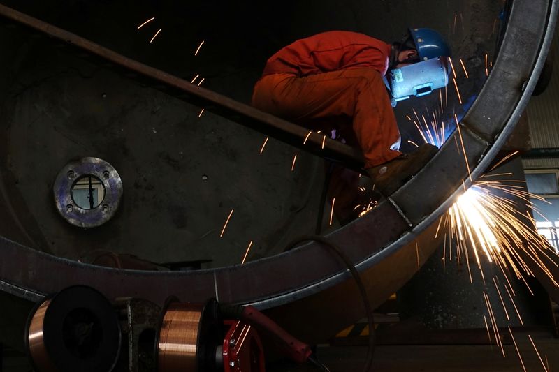 Worker of Dongbei Special Steel welds a steel structure at