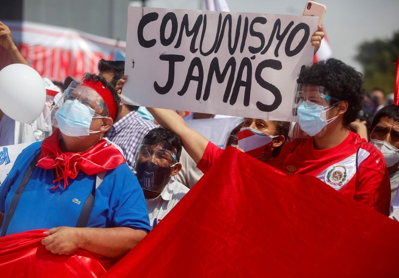FILE PHOTO: People protest against Peru’s presidential socialist candidate Pedro