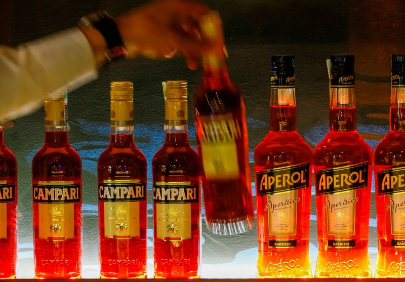 FILE PHOTO: A bartender takes a bottle of Campari at
