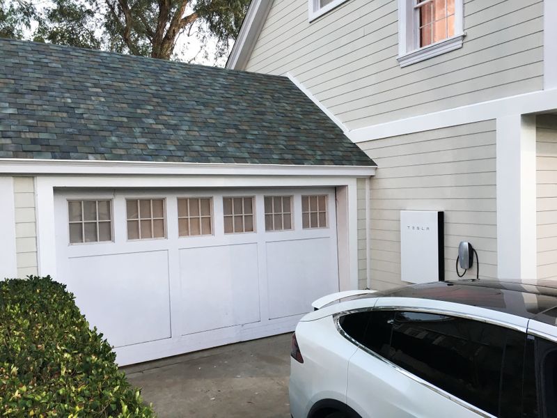Tesla’s electric car, Powerwall and solar roof are shown at