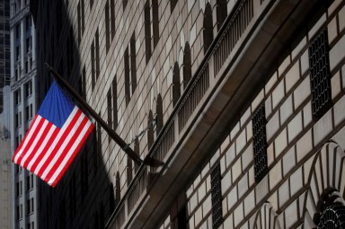 A U.S. flag flies outside The Federal Reserve Bank of