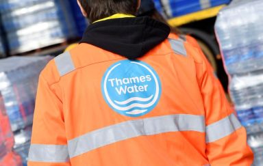 FILE PHOTO: A Thames Water operative views pallets of bottled