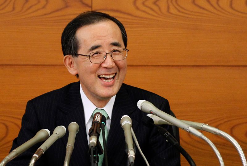 Outgoing Bank of Japan Governor Masaaki Shirakawa smiles during his