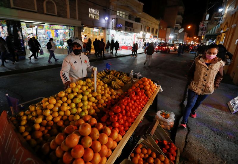 A fruit seller looks on as he waits for customers