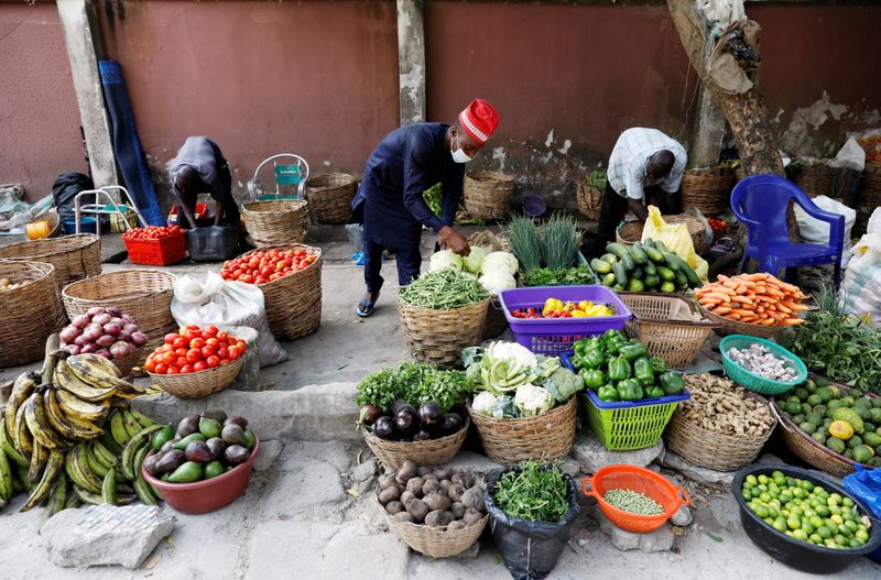 FILE PHOTO: Vendors sell vegetables at a street market in