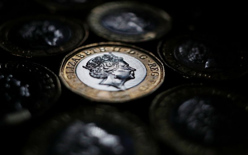 Pound coins are seen in the photo illustration taken in