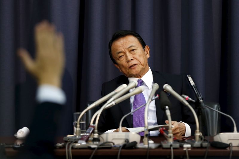 Japan’s Finance Minister Taro Aso attends a news conference as
