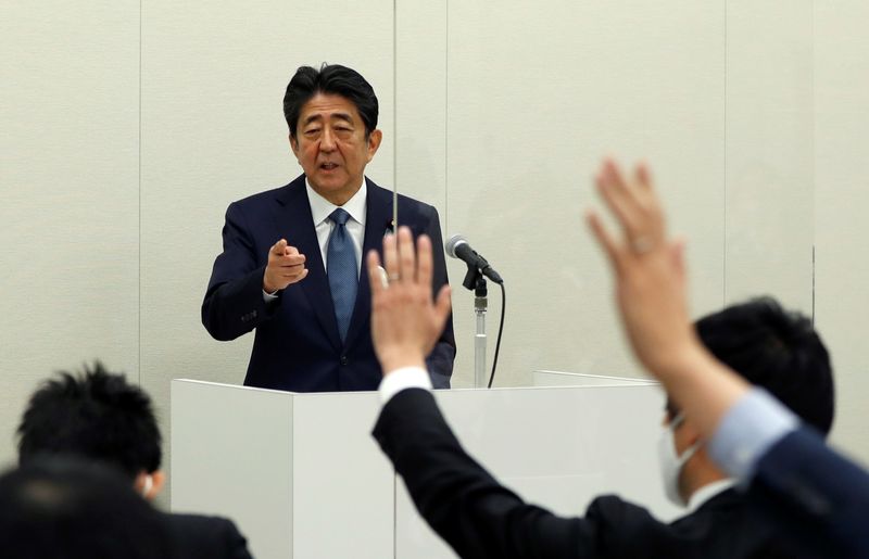 FILE PHOTO: Former Japanese PM Shinzo Abe holds a news