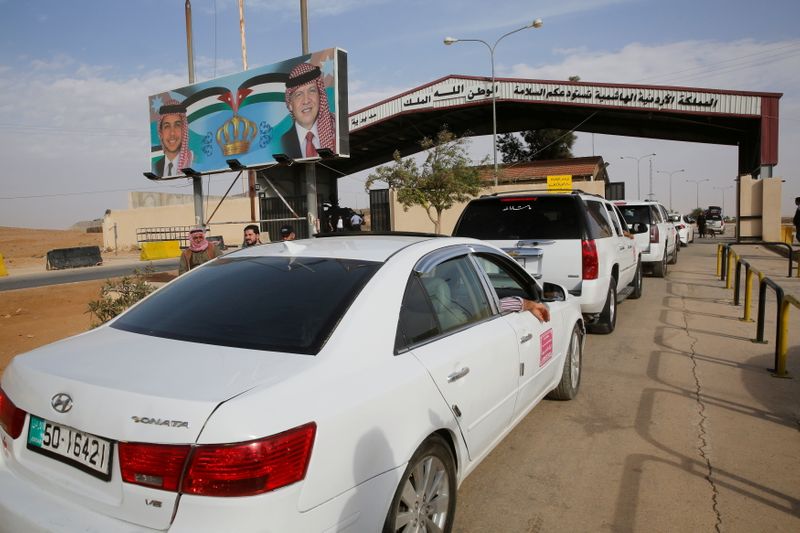 FILE PHOTO: Jordanian police officers check the cars at Jordan’s