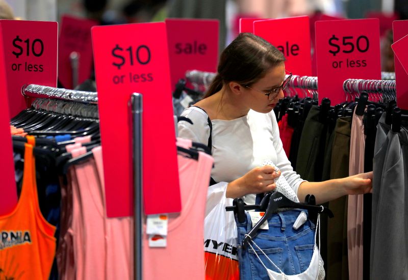 FILE PHOTO: A shopper holds items and looks at others