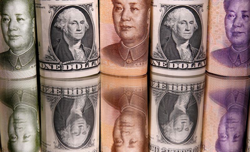 FILE PHOTO: Chinese Yuan and U.S. dollar banknotes are seen