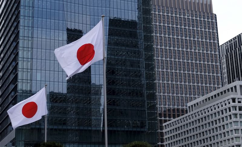 Japanese national flags flutter in front of buildings at Tokyo’s
