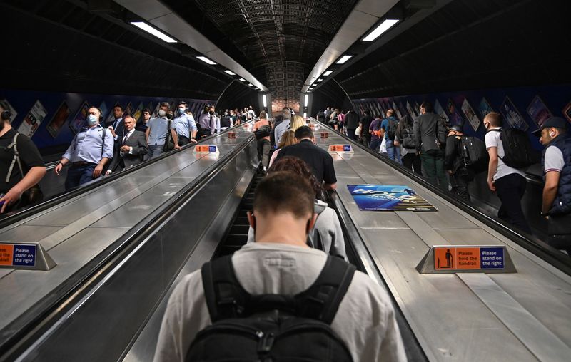 Workers travel through London Bridge rail and underground station during