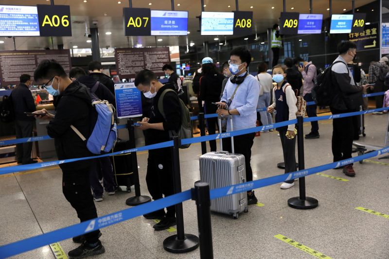 FILE PHOTO: Travellers at Taoxian International Airport ahead of China’s