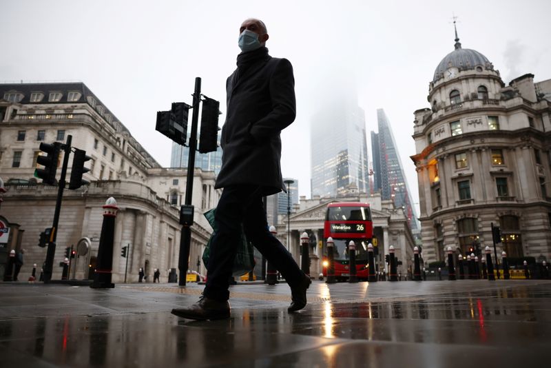 A man walks through the City of London financial district,