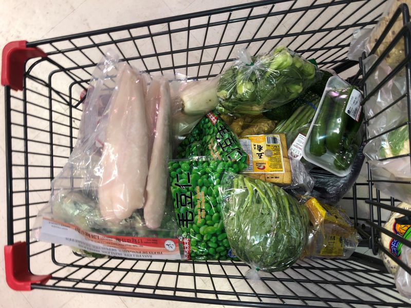 A customer’s cart filled with the shopping supplies they’re purchasing