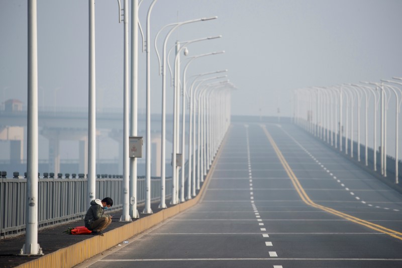 FILE PHOTO: A man who arrived from Hubei province sits