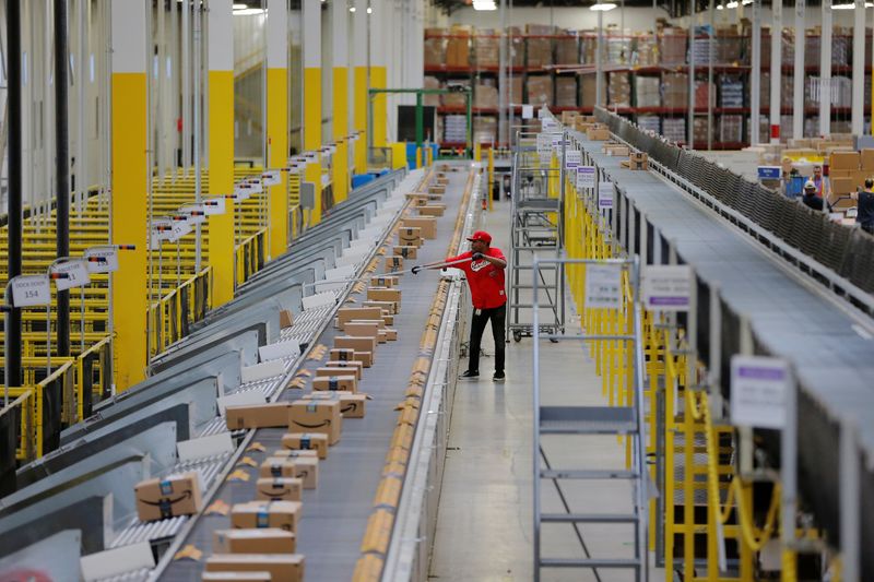 A worker clears a machine jam inside of an Amazon