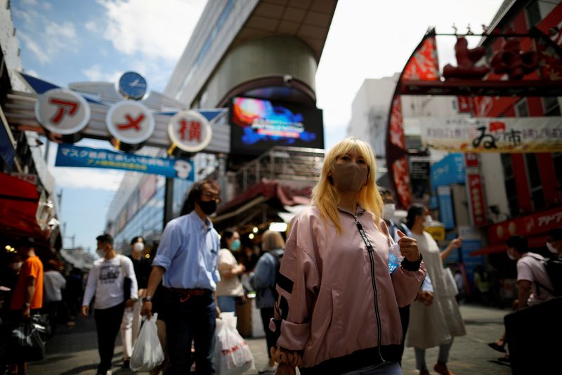 FILE PHOTO: Shoppers walk at the Ameyoko shopping district where