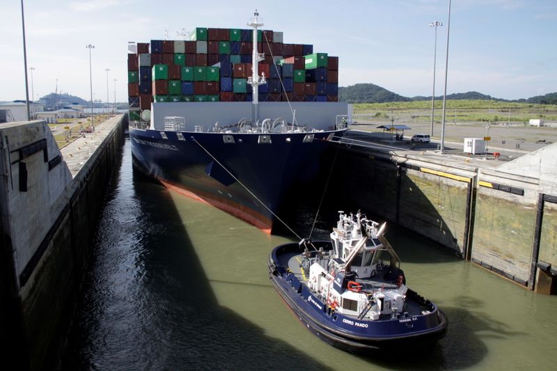FILE PHOTO: Tugboat drags cargo vessel during its transit at