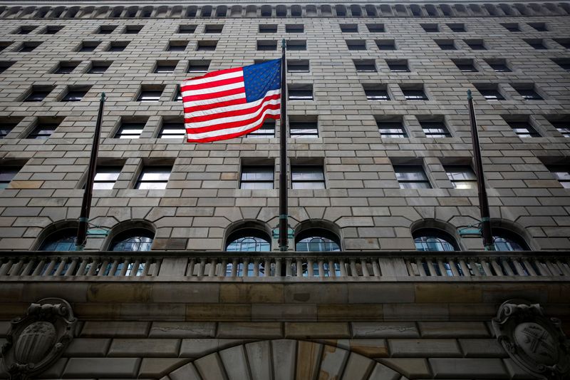 The U.S. flag flies outside The Federal Reserve Bank of
