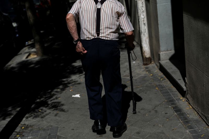 FILE PHOTO: A pensioner goes for a walk in Madrid