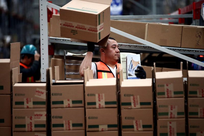 FILE PHOTO: An employee of Estafeta Mexicana holds a box