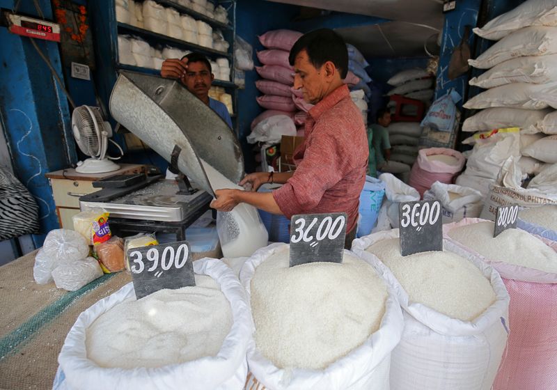 A man packs sugar for sale inside a shop at
