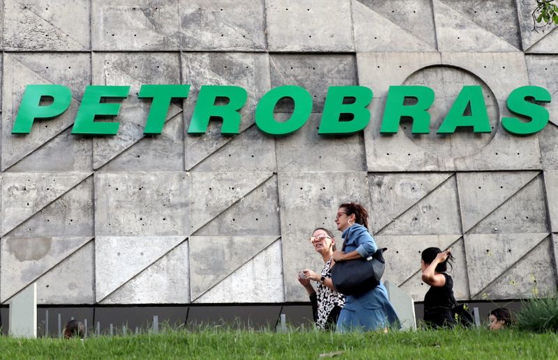 FILE PHOTO: People walk in front of Brazil’s state-run Petrobras