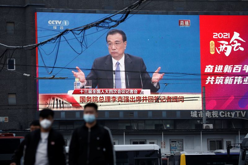 A giant screen shows Chinese Premier Li Keqiang attending a