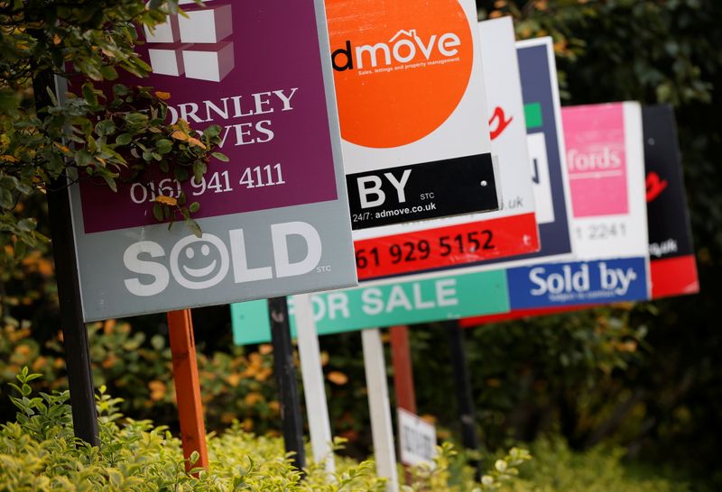 Estate Agent’s boards are lined up outside a housing development