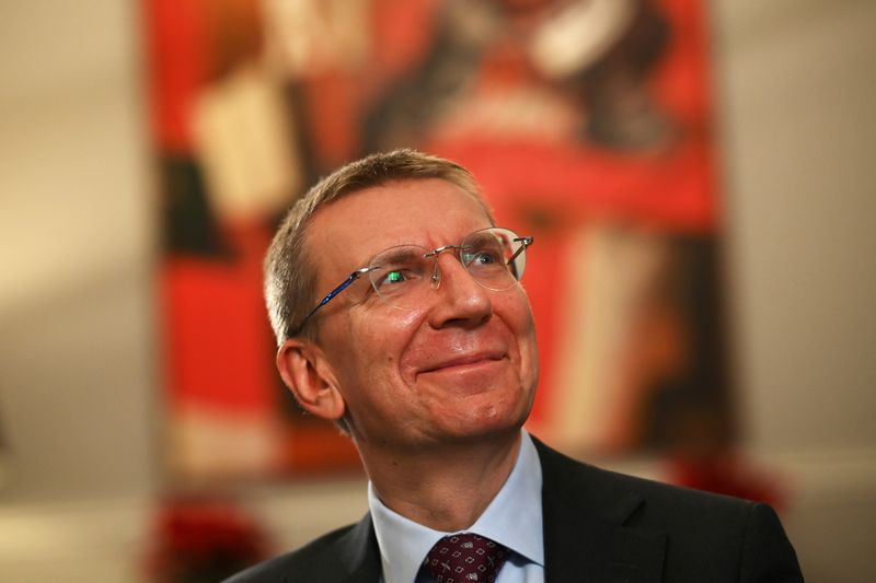 Latvian Foreign Minister Edgars Rinkevics smiles during an interview with