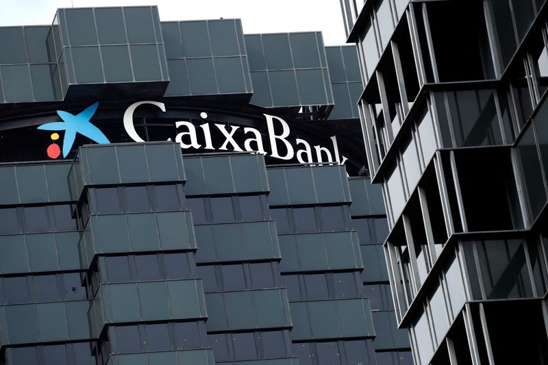 CaixaBank’s logo is seen on top of the company’s headquarters