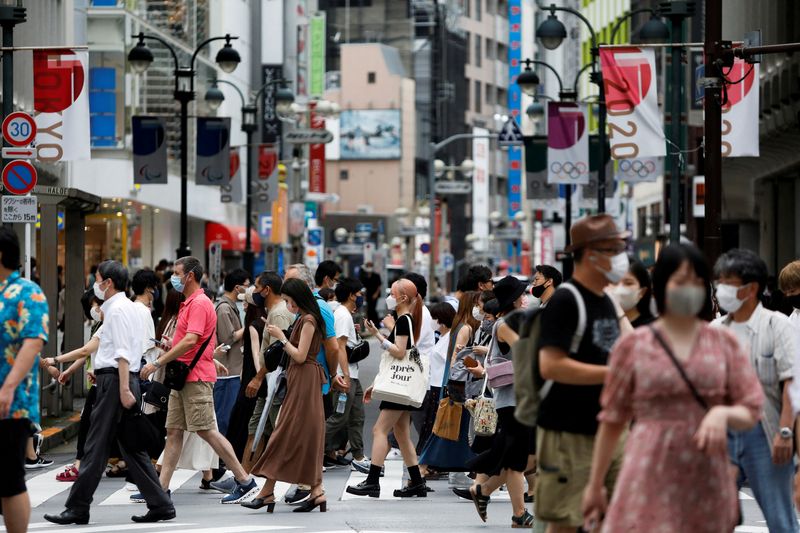 FILE PHOTO: People walk at a crossing in Shibuya shopping