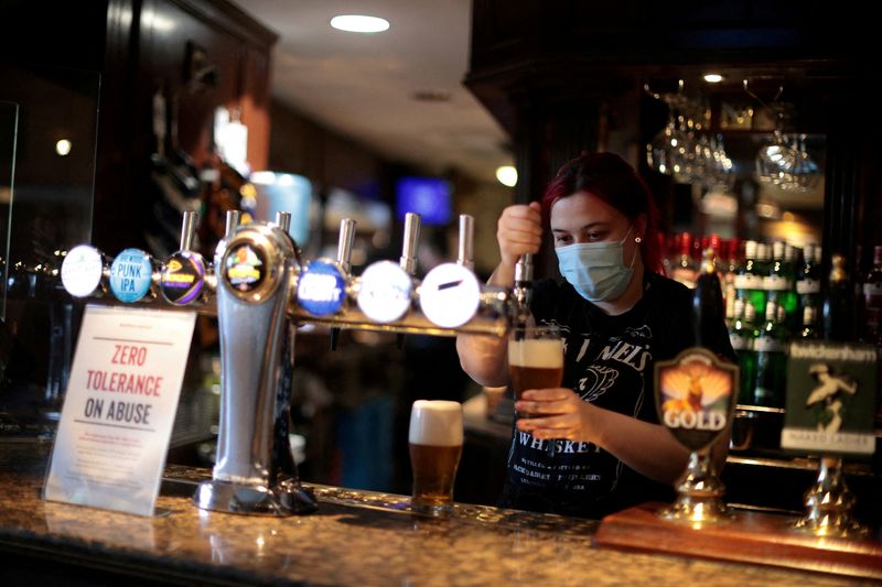FILE PHOTO: A woman pouring beer at a pub in