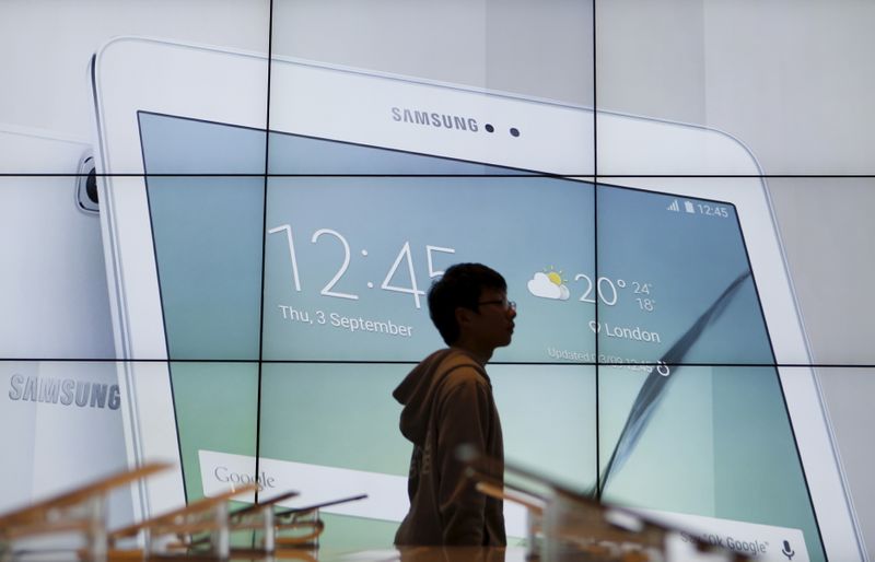 A student walks past an electronic display promoting Samsung Electronics
