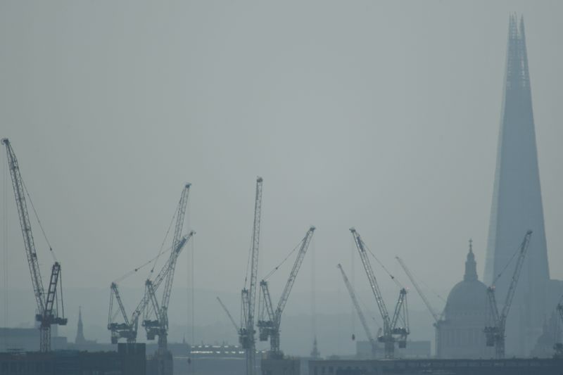 Construction cranes are seen with St Paul’s Cathedral and the